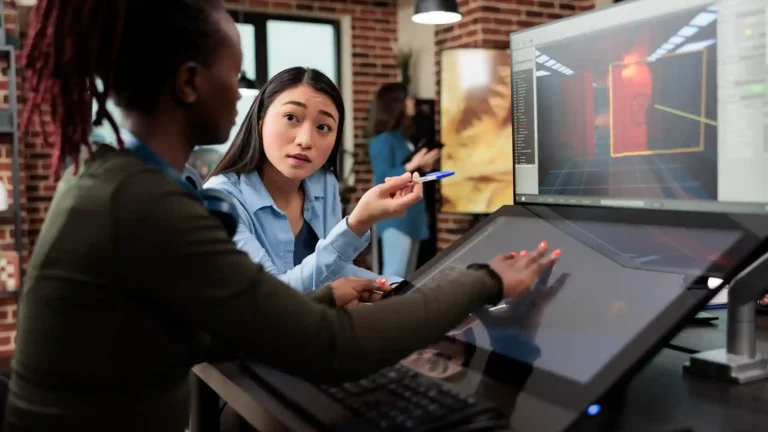 Team of developers collaborating in a modern office environment, representing the innovative work culture in the Best Cities for Startup IT Jobs in the World.